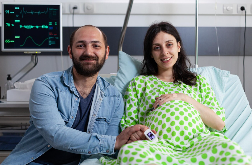 Pregnant woman smiling during prenatal care consultation at Om Global Hospital